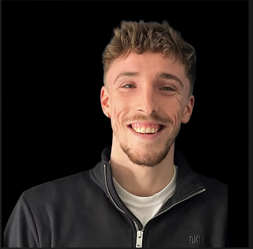 Sam Finnegan-Dehn smiling against a dark background